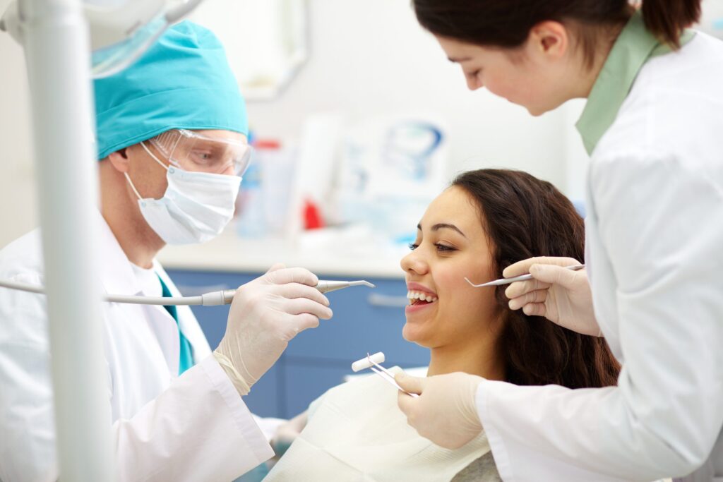 Broadway Smile Boutique Dentists examining patients teeth for Veneers